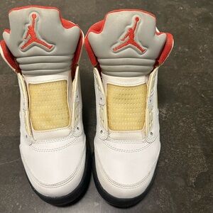 Junior size (5Y) Jordan 5 white, red,  and black.